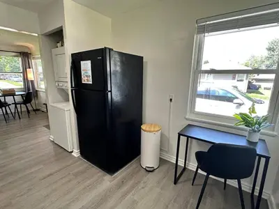 a black refrigerator in a room with a table and a window at KING bed, Pet Friendly, Modern Retreat in CLE-BW in Berea