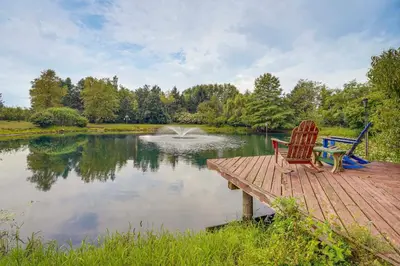 two chairs sitting on a wooden dock next to a pond at Fish, Hike and Golf Countryside Retreat in Bluffton in Bluffton