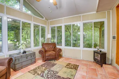 a living room with a couch and chair and windows at Fish, Hike and Golf Countryside Retreat in Bluffton in Bluffton