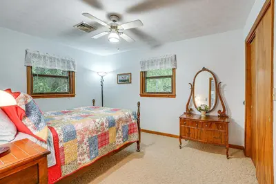 a bedroom with a bed and a dresser and a mirror at Fish, Hike and Golf Countryside Retreat in Bluffton in Bluffton
