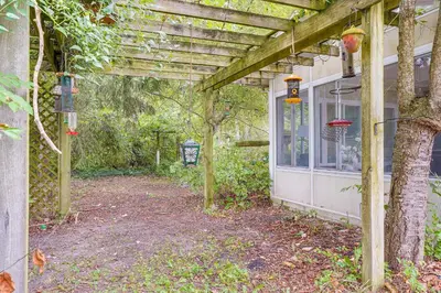 a wooden pergola on the side of a house at Fish, Hike and Golf Countryside Retreat in Bluffton in Bluffton