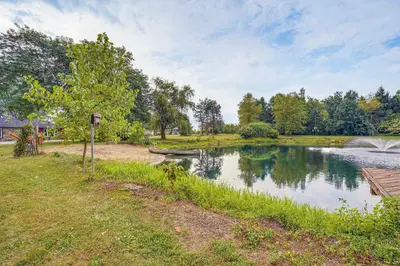 a lake with a boat on the side of it at Fish, Hike and Golf Countryside Retreat in Bluffton in Bluffton