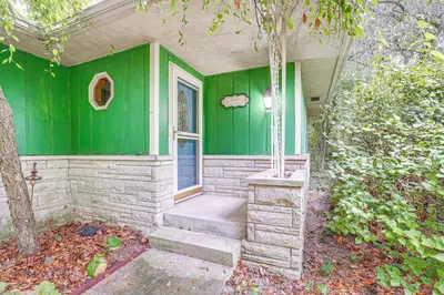 a green house with stairs leading to a door at Fish, Hike and Golf Countryside Retreat in Bluffton in Bluffton