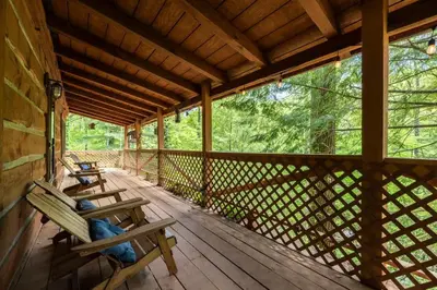 a porch of a cabin with benches on it at Outdoors Sleeps7 Family Getaway Fun Arcade in Rockbridge