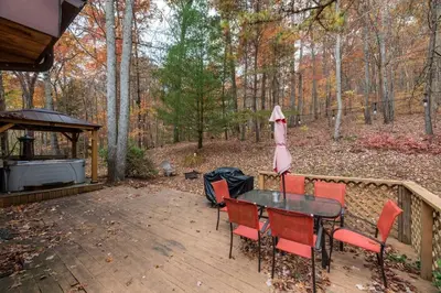 a patio with a table and chairs and a grill at Outdoors Sleeps7 Family Getaway Fun Arcade in Rockbridge