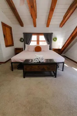 a bedroom with a bed and a table with towels on it at Outdoors Sleeps7 Family Getaway Fun Arcade in Rockbridge