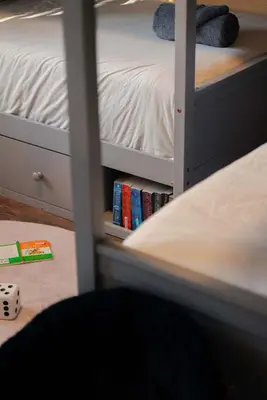 a bedroom with a bunk bed with books at The Treetop Retreat – Family Getaway in Scenic Hocking Hills in Logan