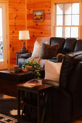 a living room with a couch and a table at Sleeps 16! Luxury Cabin with Game Room & Hot Tub in Nelsonville