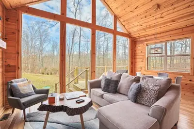 a living room with a couch and chairs in a cabin at Fern Haven A modern take on Hocking Hills cabins in McArthur