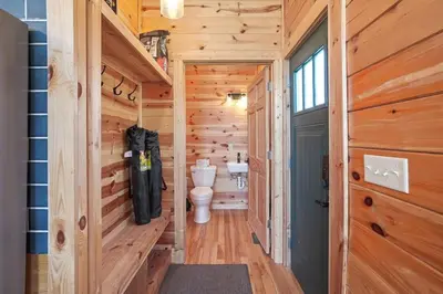 a bathroom with a toilet in a wooden house at Fern Haven A modern take on Hocking Hills cabins in McArthur