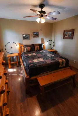 a bedroom with a bed and a ceiling fan at Cheerful Two Bdrm Cabin with Hot Tub & Pet Friendly in Lancaster