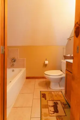 a bathroom with a tub and a toilet and a sink at Cheerful Two Bdrm Cabin with Hot Tub & Pet Friendly in Lancaster