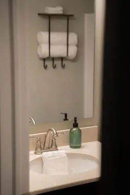 a bathroom sink with a green soap dispenser on it at Modern 2 BD cabin with hot tub & Games & Central Loc in Rockbridge