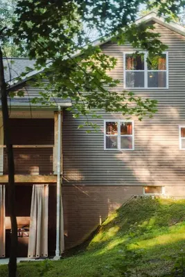 a house with a building with a garage at Modern 2 BD cabin with hot tub & Games & Central Loc in Rockbridge