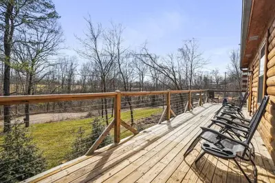 a deck with benches on the side of a house at Modern Luxury I Hot Tub I Hiking in McArthur