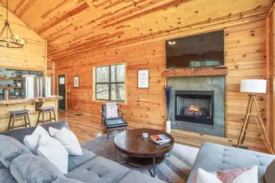 a living room with a couch and a fireplace at Modern Luxury I Hot Tub I Hiking in McArthur