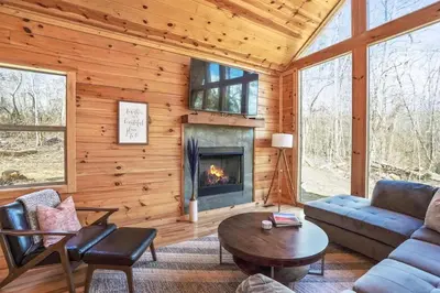 a living room with a couch and a fireplace at Modern Luxury I Hot Tub I Hiking in McArthur