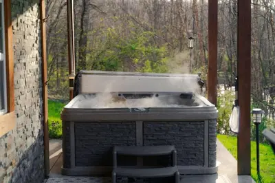 a barbecue grill with smoke coming out of it at COZY Cabin with Hot Tub - Near all in Hocking Hills in Logan