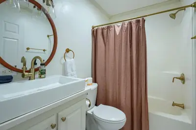 a bathroom with a sink and a toilet and a shower at Buckingham Woods I Hocking Hills in Logan