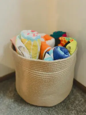 a basket filled with different types of towels at Blue Heron Cottage with Game Room, Deck & Hot Tub in Logan