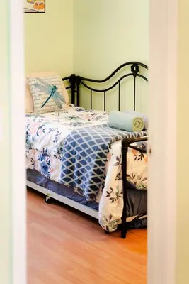 a bedroom with a bed with a quilt on it at Blue Heron Cottage with Game Room, Deck & Hot Tub in Logan