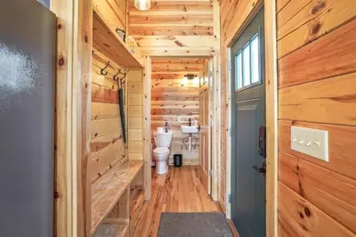 a bathroom with a toilet in a wooden house at Fern Woods A modern take on Hocking Hills cabins in McArthur