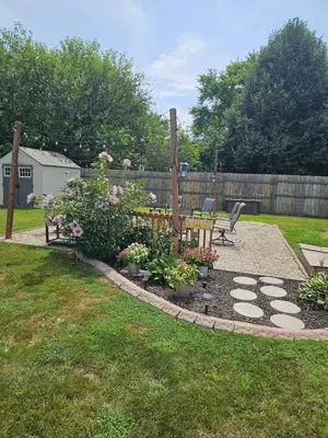 a garden with a bench and flowers in a yard at Tranquil Stay Close to Hotspots