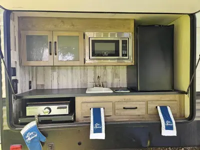 a kitchen in the back of an rv at Tranquil Stay Close to Hotspots