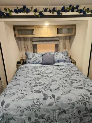 a bedroom with a bed with a blue and white comforter at Tranquil Stay Close to Hotspots
