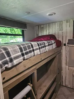a bed on top of a wooden platform in a room at Tranquil Stay Close to Hotspots