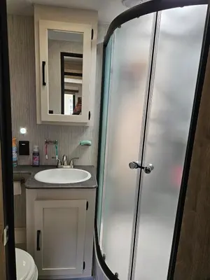 a bathroom with a shower and a sink at Tranquil Stay Close to Hotspots