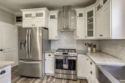 a kitchen with white cabinets and stainless steel appliances at Modern Comfort Near Columbus Home with Yard and Porch in London