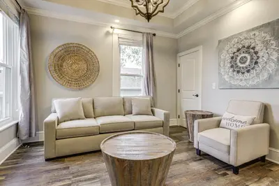 a living room with a couch and chairs and a chandelier at Modern Comfort Near Columbus Home with Yard and Porch in London