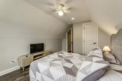a bedroom with a bed and a flat screen tv at Modern Comfort Near Columbus Home with Yard and Porch in London