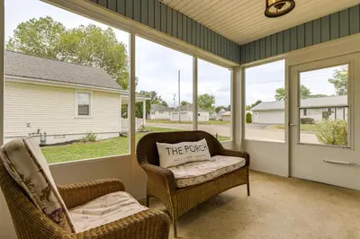 a screened porch with two chairs and a pillow that reads the purpose at Modern Comfort Near Columbus Home with Yard and Porch in London