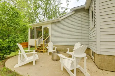a group of white chairs sitting on a patio at Modern Comfort Near Columbus Home with Yard and Porch in London