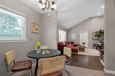 a living room with a table and chairs at Spacious 5BR Firepit with Deck Near OSU and More in Columbus