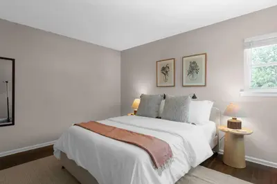 a white bedroom with a large bed and a window at Spacious 5BR Firepit with Deck Near OSU and More in Columbus