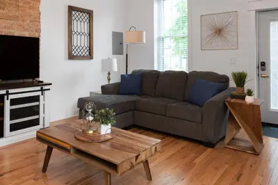 a living room with a couch and a coffee table at 2BR Townhome - Free Parking, Minutes to Stadiums in Covington