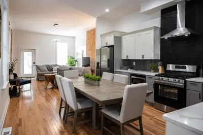 a kitchen and living room with a wooden table and chairs at Two Condos for 14 Guests, 5 Bedrooms, Free Parking in Covington