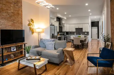 a living room with a couch and a tv at Two Condos for 14 Guests, 5 Bedrooms, Free Parking in Covington