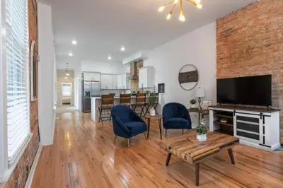 a living room with a television and a table and chairs at Two Condos for 14 Guests, 5 Bedrooms, Free Parking in Covington