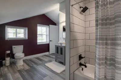 a bathroom with a toilet and a sink and a tub at 3 Bedroom Condo - Close to Stadiums & Downtown in Covington