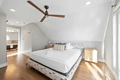 a bedroom with a bed and a ceiling fan at Next to Monastery Wedding Venue, 2BR with Balcony in Cincinnati