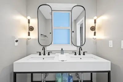 a bathroom with two sinks and a mirror at Next to Monastery Wedding Venue, 2BR with Balcony in Cincinnati