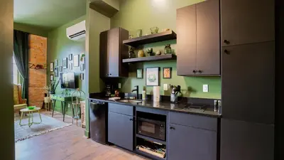 a kitchen with a sink and a stove at Pickle Factory Hotel - 2BR Near Stadiums & Downtown in Covington
