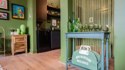a room with a blue table with glasses on it at Pickle Factory Hotel - 2BR Near Stadiums & Downtown in Covington
