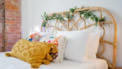 a bunch of pillows sitting on a white couch at Pickle Factory Hotel - 1BR Near Bars & Restaurants in Covington
