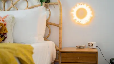 a bedroom with a bed and a mirror on the wall at Pickle Factory Hotel - 1BR Near Bars & Restaurants in Covington