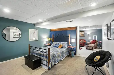 a bedroom with a bed and a chair in it at 10 Mi to Dtwn Cozy Couples Getaway in Cincinnati in Cincinnati